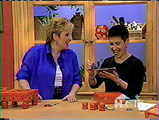 Sharing a laugh with Sue Warden on HGTV, artist Debra Gould demonstrates how she creates her one of a kind treasure boxes.