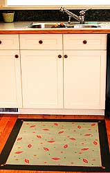 "My kitchen looks so much better with the floorcloth in front of the sink. It really ties in the granite backsplash and the red chest in our family room. The other day the garbage leaked all over it and I couldn't believe how easy it was to clean. You were right, it does stand up to a lot!" - Susan Bing, Victoria - Custom painted 3' x 3.5' floorcloth based on an existing design from the Home Collection. A new colour palette was developed to match the Client's home..